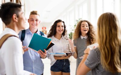 High school teens standing around holding books