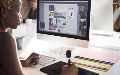 Woman designing a booklet on a laptop using Photoshop