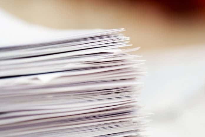 Close up of a stack of white papers