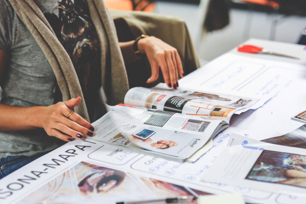 Woman flipping through the pages of a magazine that is perfect bound.