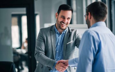 Portrait of cheerful young manager handshake with new client