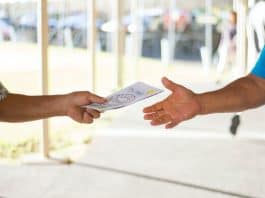 A person passing out company brochure