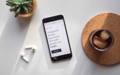 A phone, drink, and plant on a white background