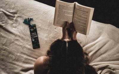 Person reading a book with a bookmark next to them