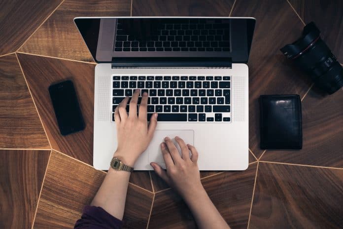 person typing on laptop