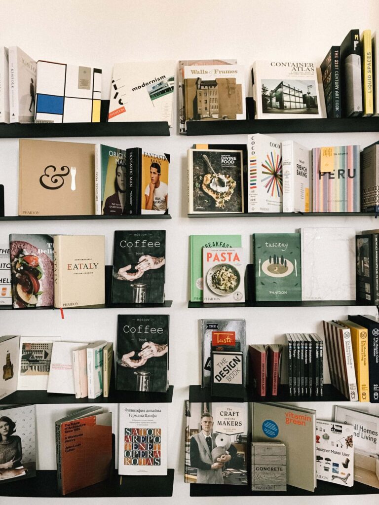 Hardcover books on a shelf with their front cover facing out