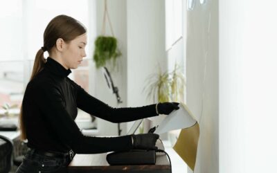 Women in black putting paper into a printer