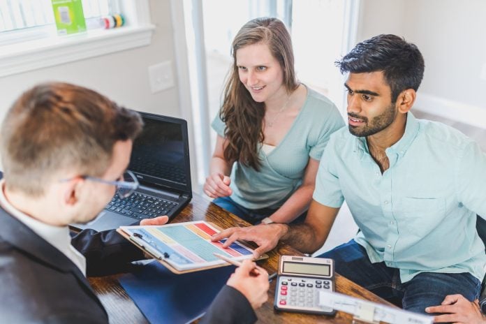 Couple sitting own with a realtor