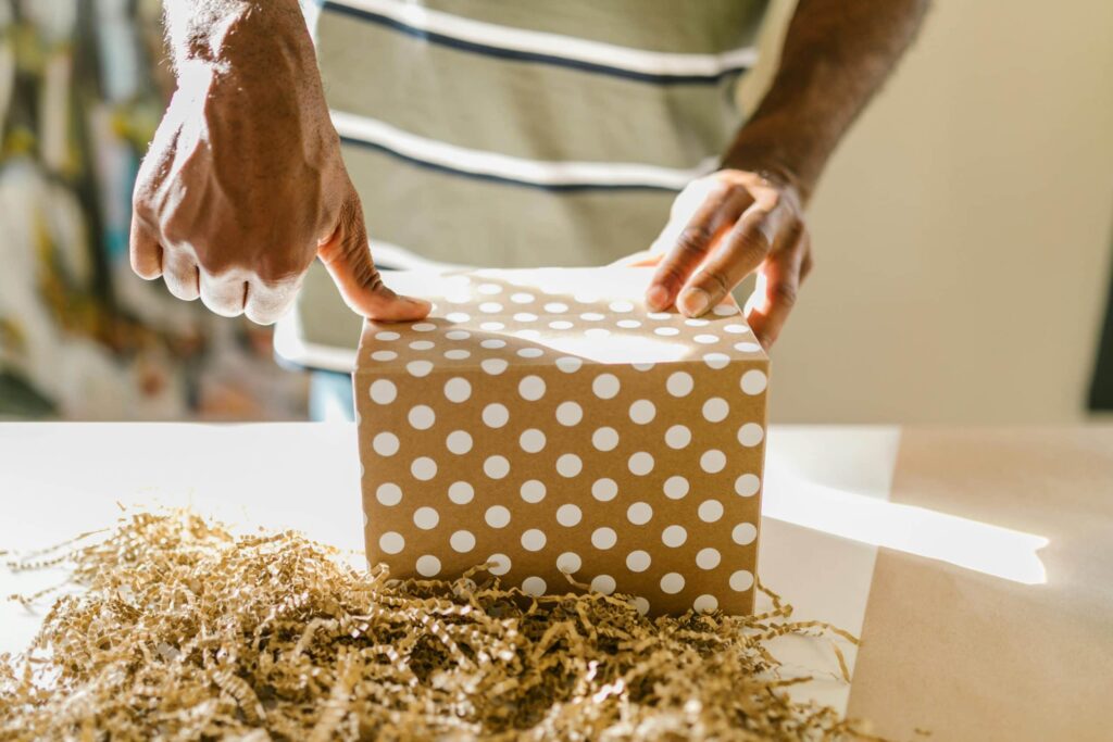 Person taping a printed shipping box